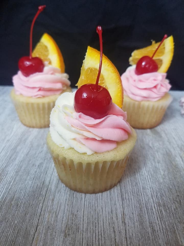 tequila sunrise cupcakes with cherry and orange slice on top