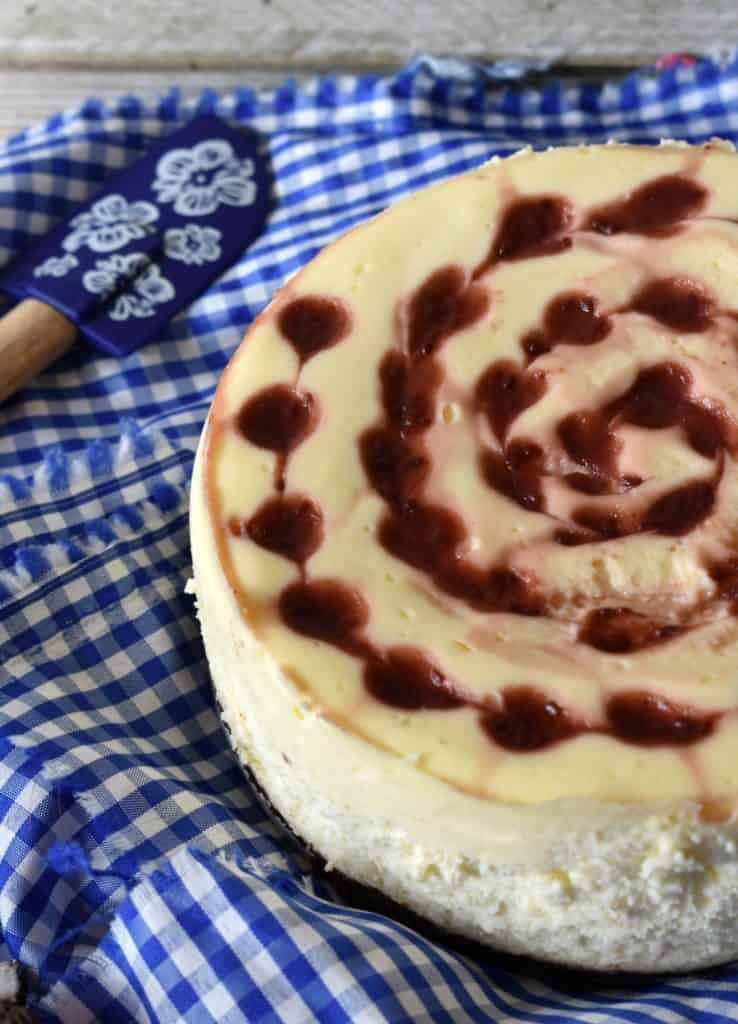 Instant Pot Raspberry Cheesecake on blue checkered towel