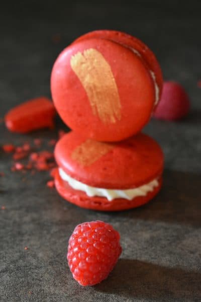 Incredible White Chocolate and Raspberry Macarons | These white chocolate raspberry macarons are simply incredible. From their perfect crisp red shell, to the creamy white chocolate ganache filling. | https://butterysweet.com/macarons/incredible-white-chocolate-&-raspberry-macarons