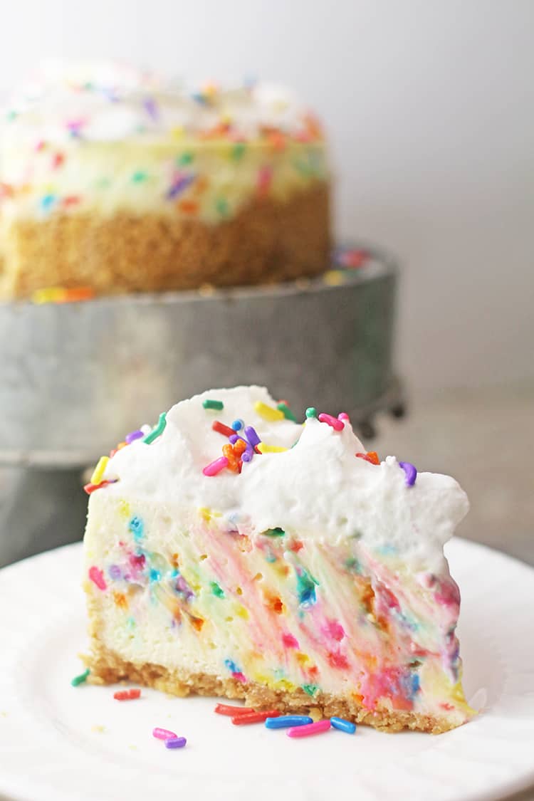 Slice of Instant Pot Funfetti Cheesecake on a white plate
