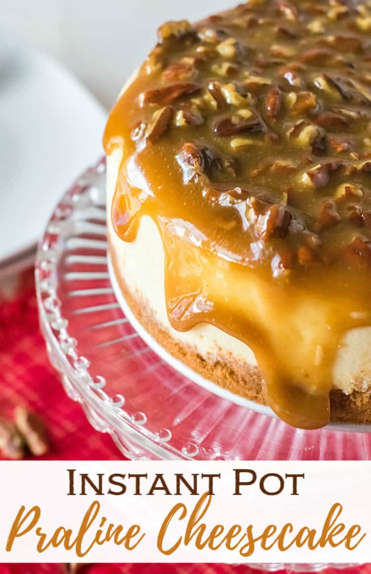 Instant pot praline cheesecake on a cake plate dripping with caramel and pecans
