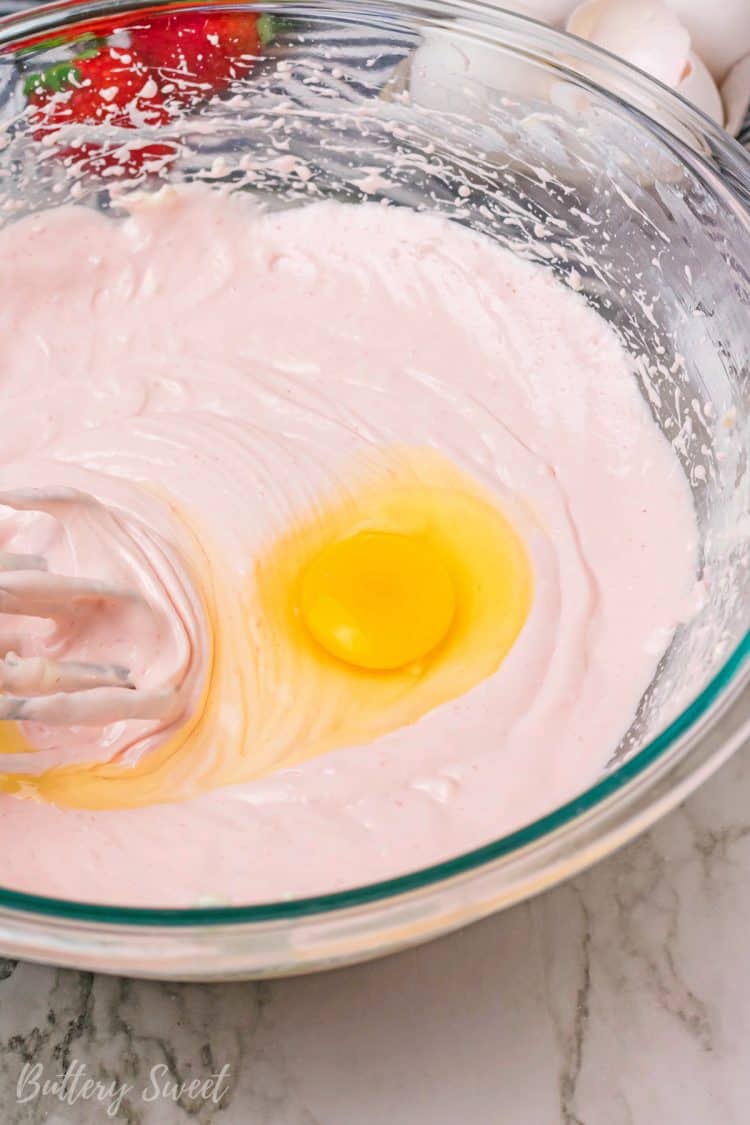 adding eggs to Instant Pot Chocolate Covered Strawberry Cheesecake batter