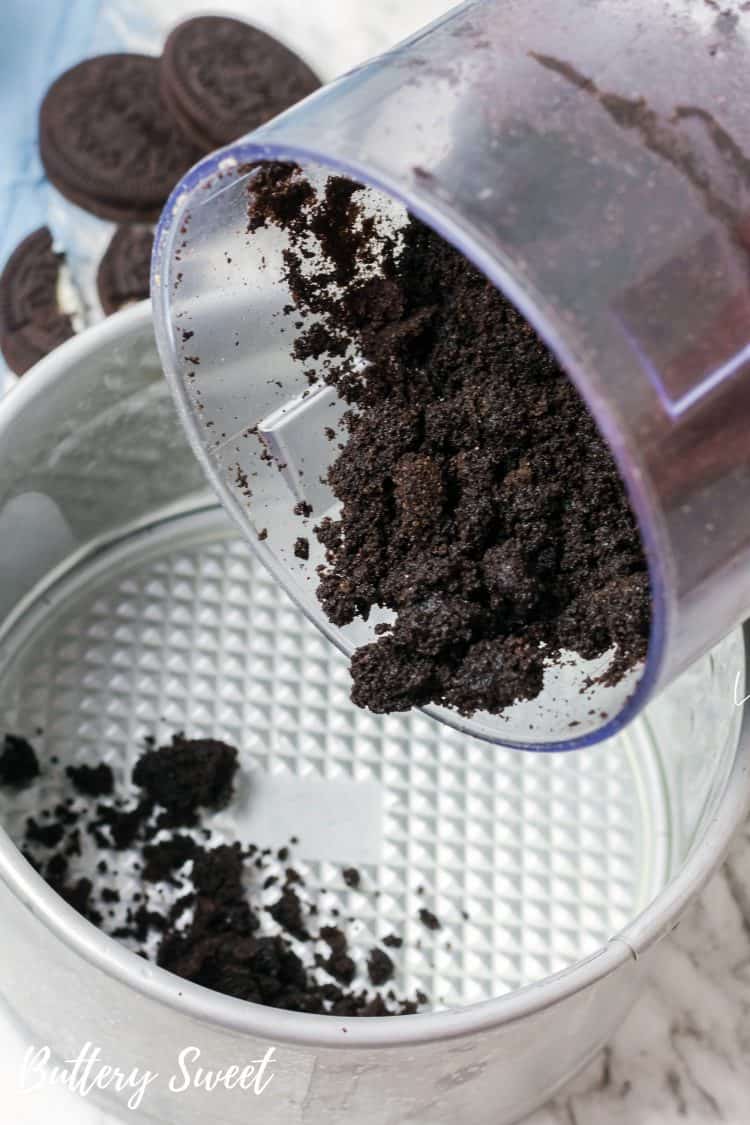 Pouring crushed OREOs into 6-inch springform pan for IP OREO Cheesecake