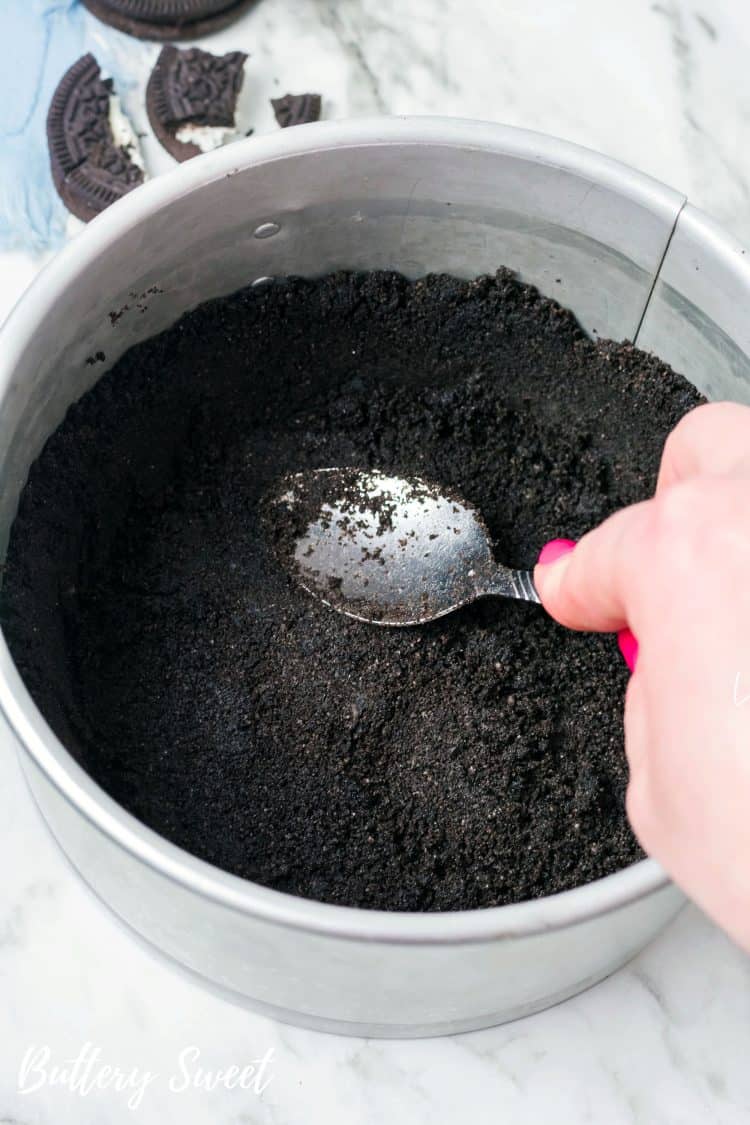 pressing OREO crust into 6-inch springform pan for Instant Pot OREO Cheesecake