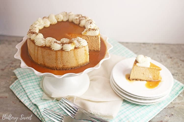 Instant Pot Pumpkin Pie Cheesecake with a slice on a stack of plates next to it.