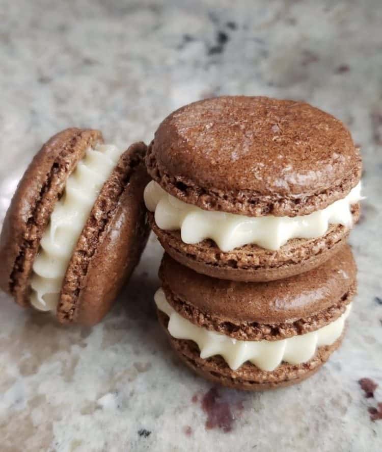 Stack of chocolate macarons filled with cream cheese frosting